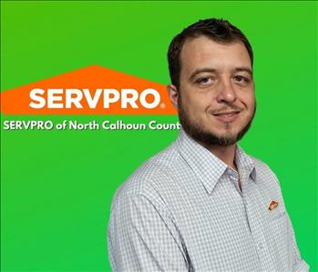 Caucasian young gentleman in white gingham checked shirt, brown hair with beard. With Green back ground and SERVPRO logo. 